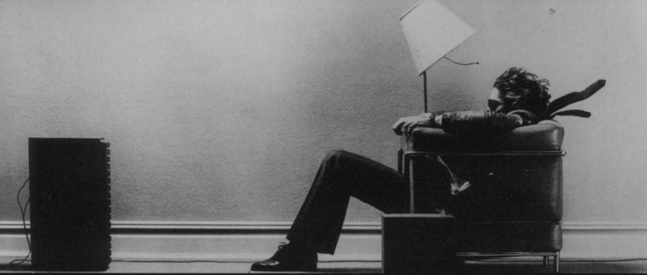Black-and-white Maxell advertisement of a man in an armchair blown back by sound from a loudspeaker