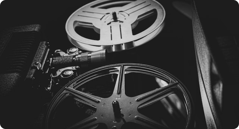 Black-and-white film reels mounted on a projector